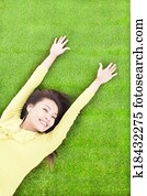 High angle view of  pretty  woman relaxing and lying on grass