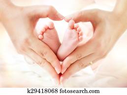 baby feet in mother hands - hearth baby feet in mother hands - hearth