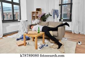 drunk man sleeping on sofa in messy room at home drunk man sleeping on sofa in messy room at home