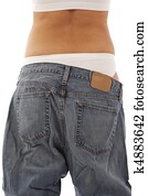 Young woman showing off weight loss