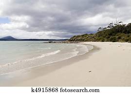 Wide bright beach with lapping waves