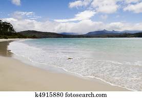 Wide bright beach with lapping waves