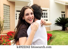 Couple standing outside new house