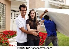 Moving home: Couple infront of new house Moving home: Couple infront of new house