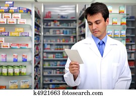 pharmacist reading prescription at pharmacy pharmacist reading prescription at pharmacy