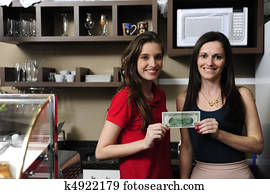 Small business: Owners of a cafe holding cash Small business: Owners of a cafe holding cash