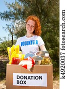 volunteer carrying food donation box