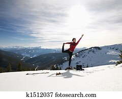 Woman doing yoga in snow.