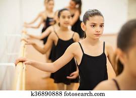 Little girls paying attention to dance class