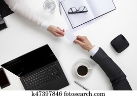 Business People Exchanging Visiting Card At Office Desk