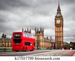 London, the UK. Red bus in motion and Big Ben
