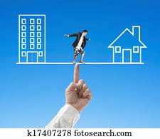 Businessman surfing on seesaw with Office and home, for index finger to balance Businessman surfing on seesaw with Office and home, for index finger to balance