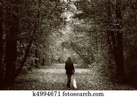 Lonely sad woman on the wood road Lonely sad woman on the wood road
