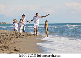 happy family playing with dog on beach happy family playing with dog on beach