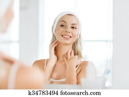 woman in hairband touching her face at bathroom woman in hairband touching her face at bathroom