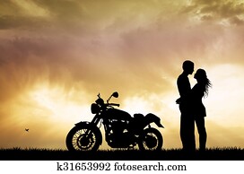 couple kissing on motorcycle couple kissing on motorcycle