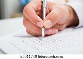 Male?s hand writing in the document Male?s hand writing in the document