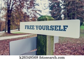 Rustic signboard outdoors in an autumn park with words Free your
