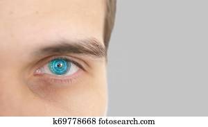 Close up of male eye with iris scan on a grey background. Future technology, identity recognition and vision concept.