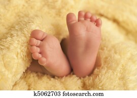 Baby feet on yellow blanket Baby feet on yellow blanket
