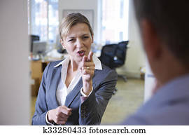Aggressive Businesswoman Shouting At Male Colleague