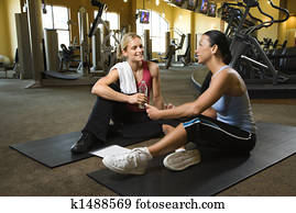 Woman with trainer at gym. Woman with trainer at gym.