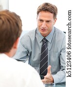 Charismatic manager during a meeting with an employee Charismatic manager during a meeting with an employee
