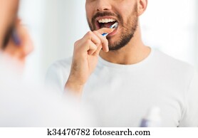 close up of man with toothbrush cleaning teeth close up of man with toothbrush cleaning teeth