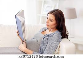 pregnant woman reading book at home pregnant woman reading book at home