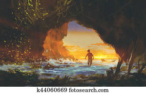 the man walking in the sea cave at sunset the man walking in the sea cave at sunset