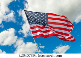 USA flag and cumulus clouds behind it