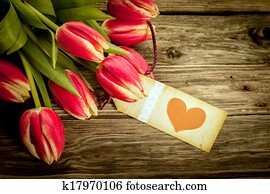 Bouquet of red tulips with a red heart gift tag Bouquet of red tulips with a red heart gift tag