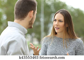 Couple talking seriously outdoors