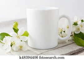 White coffee mug mockup with apple blossom White coffee mug mockup with apple blossom