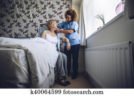 Home caregiver dressing senior Home caregiver dressing senior