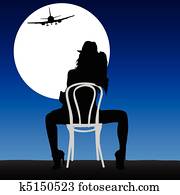 woman looking plane in the moonligh
