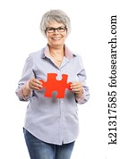 Elderly woman holding a puzzle piece