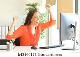 Excited entrepreneur watching computer monitor