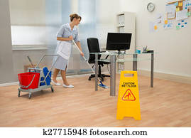 Maid Cleaning Floor In Office Maid Cleaning Floor In Office