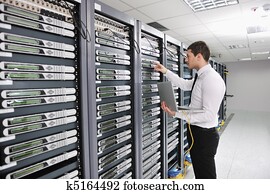 young engeneer in datacenter server room young engeneer in datacenter server room