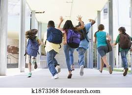 Elementary school pupils running outside