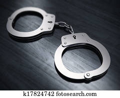 Handcuffs on wooden table Handcuffs on wooden table