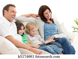 Happy family watching television together