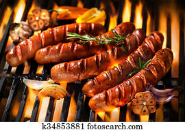 Sausages on the barbecue grill with flames Sausages on the barbecue grill with flames