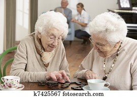 Two Senior Women Playing Dominoes At Day Care Centre Two Senior Women Playing Dominoes At Day Care Centre