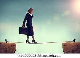 businesswoman balancing on a tightrope 