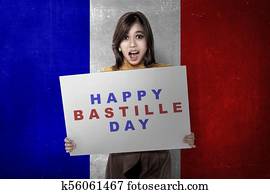 Attractive asian woman with board with Bastille day message Attractive asian woman with board with Bastille day message