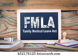 fmla, family medical leave act. Chalkboard on a wooden background fmla, family medical leave act. Chalkboard on a wooden background