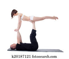 Couple of yoga trainers practising in studio