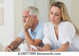 Distant couple sitting at the counter texting